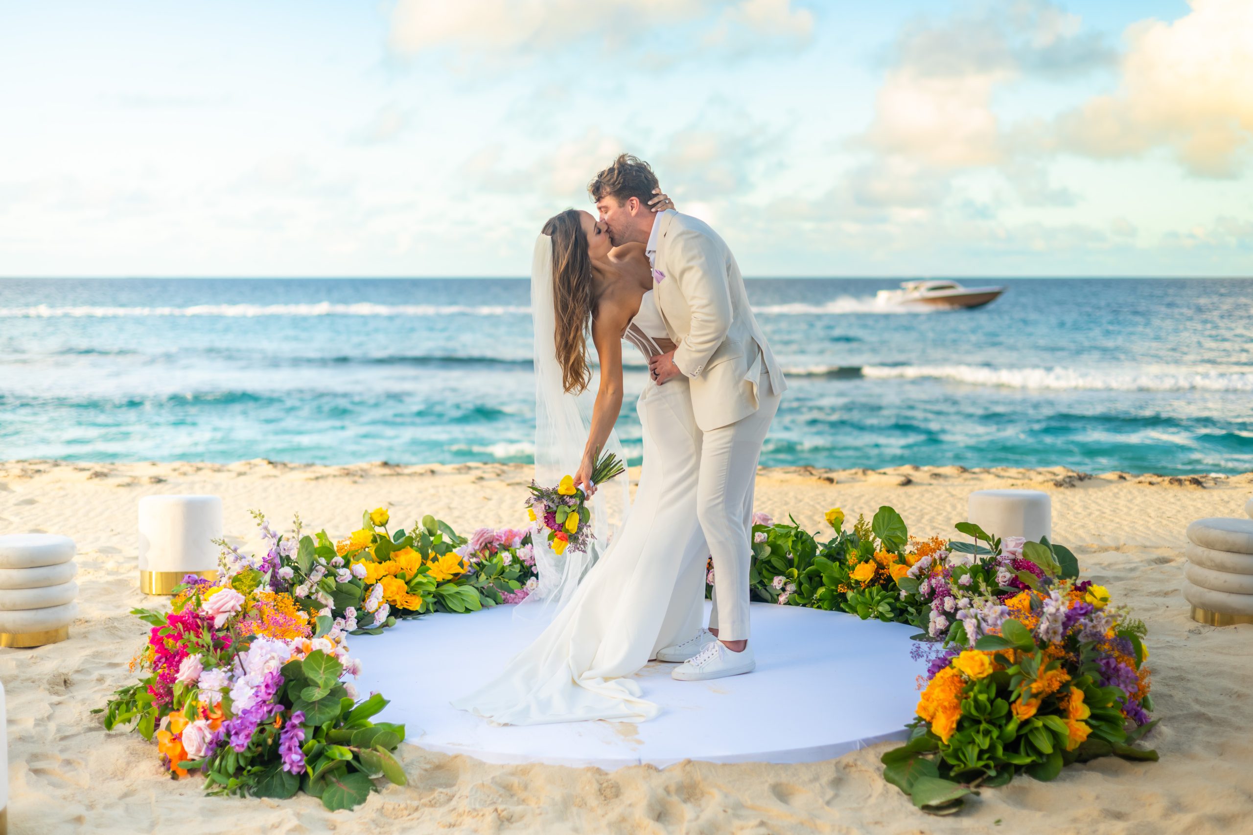 Bride and groom kissing on the beach